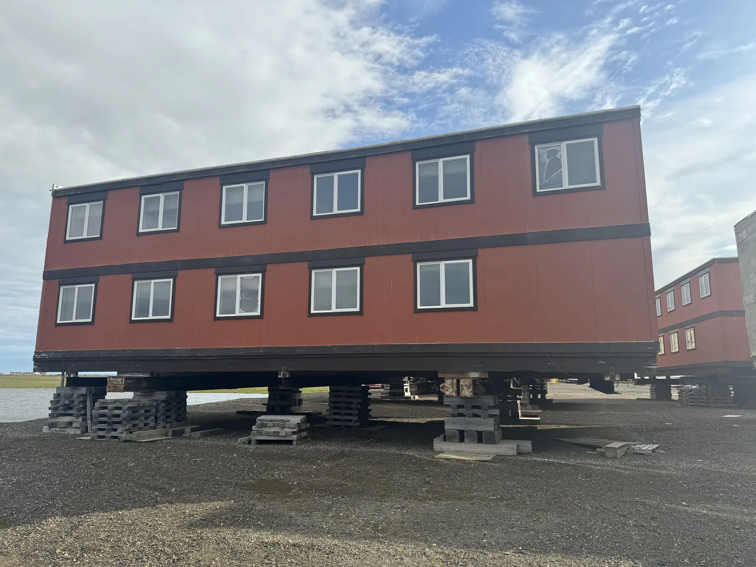 Two-story modular man-camp building at Frontier under a clear blue sky