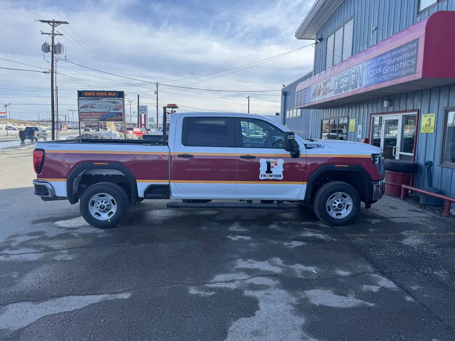 Frontier-branded GMC truck with the logo on the door