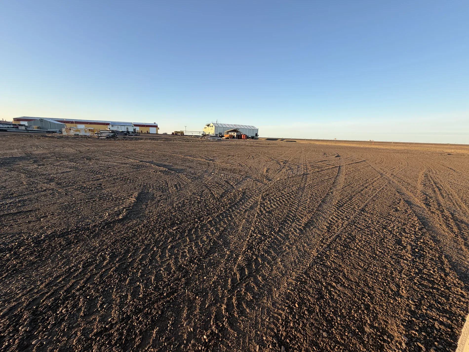 The Frontier gravel pad and buildings at golden hour